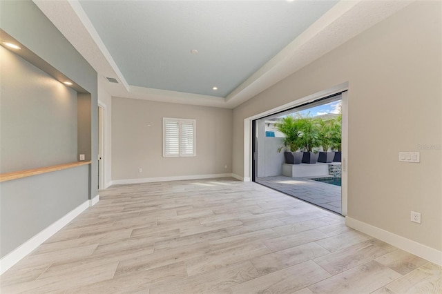 spare room with a tray ceiling