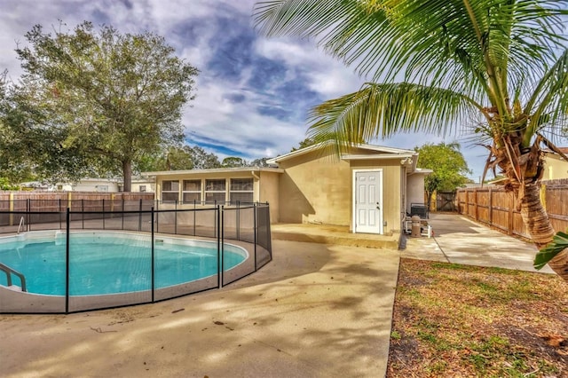 view of swimming pool with a sunroom