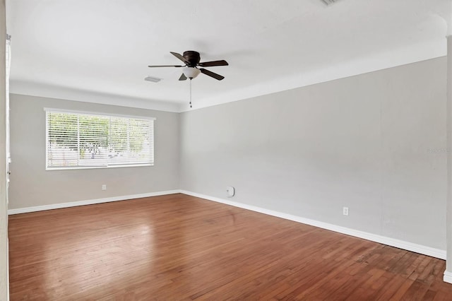 empty room featuring ceiling fan and dark hardwood / wood-style floors