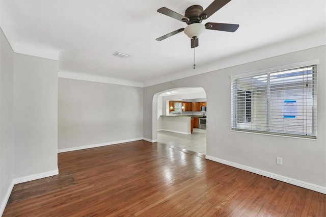 unfurnished living room featuring hardwood / wood-style flooring and ceiling fan