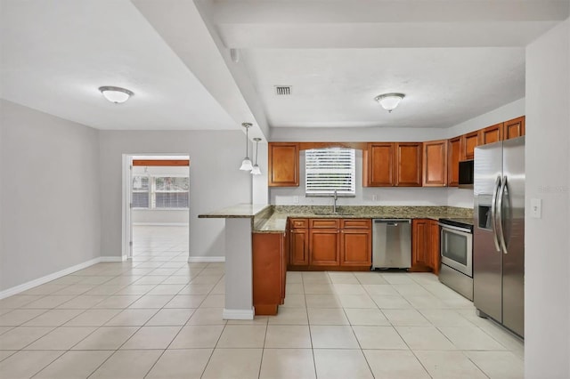 kitchen with kitchen peninsula, appliances with stainless steel finishes, sink, pendant lighting, and light tile patterned floors