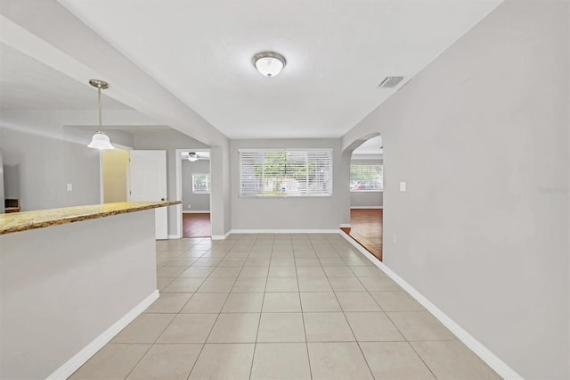 interior space with ceiling fan and light tile patterned flooring