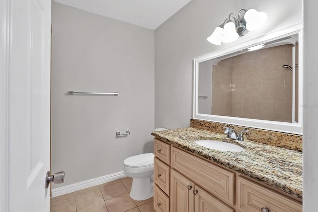 bathroom with tile patterned floors, vanity, and toilet