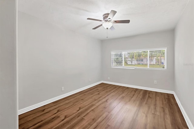 spare room featuring ceiling fan and hardwood / wood-style flooring