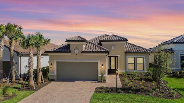 mediterranean / spanish house with a garage