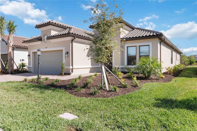 mediterranean / spanish-style home featuring a front yard and a garage