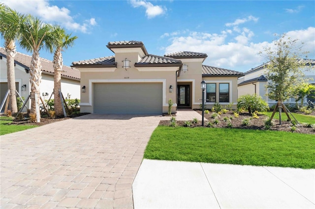 mediterranean / spanish-style home with a front lawn and a garage