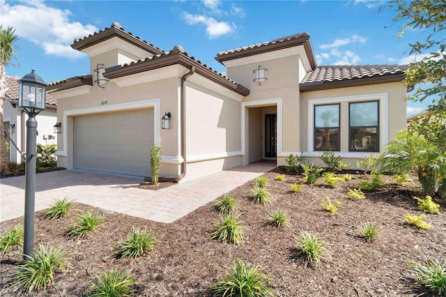 mediterranean / spanish-style house with a garage