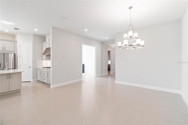 interior space featuring light tile patterned floors and a chandelier