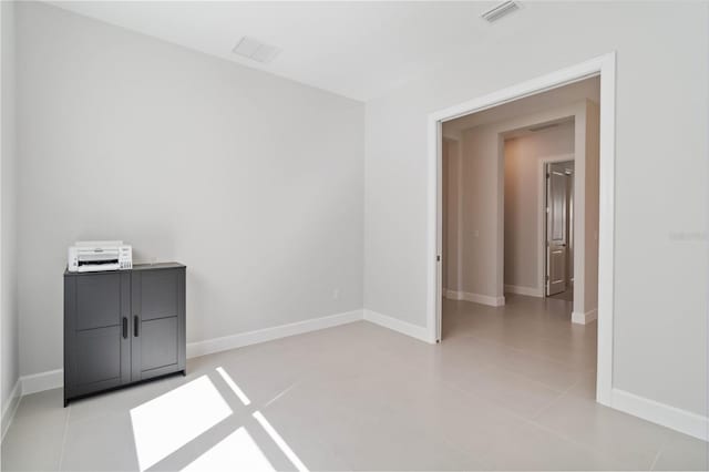 spare room with light tile patterned floors