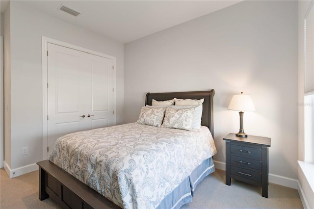 carpeted bedroom with a closet