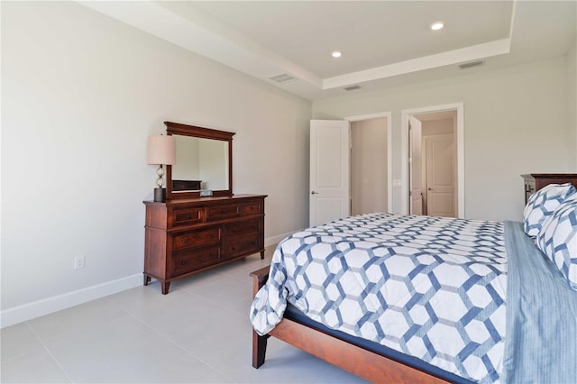 bedroom with a raised ceiling and light tile patterned flooring