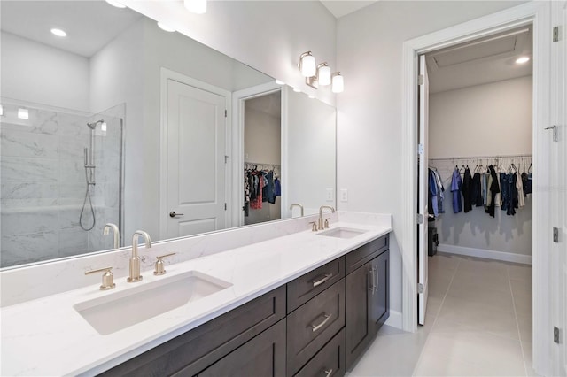 bathroom with tile patterned floors, vanity, and walk in shower