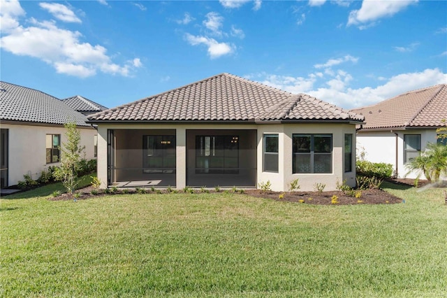 rear view of property featuring a lawn and a sunroom