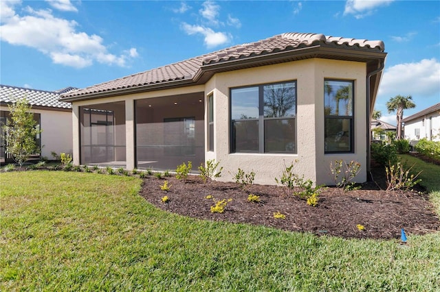 view of property exterior featuring a lawn and a sunroom