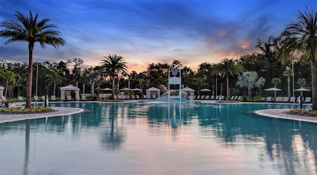 view of pool at dusk