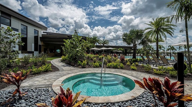 view of swimming pool featuring a community hot tub