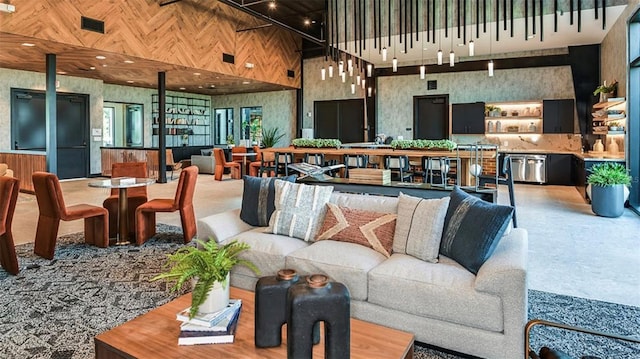 living room featuring wood walls and a towering ceiling