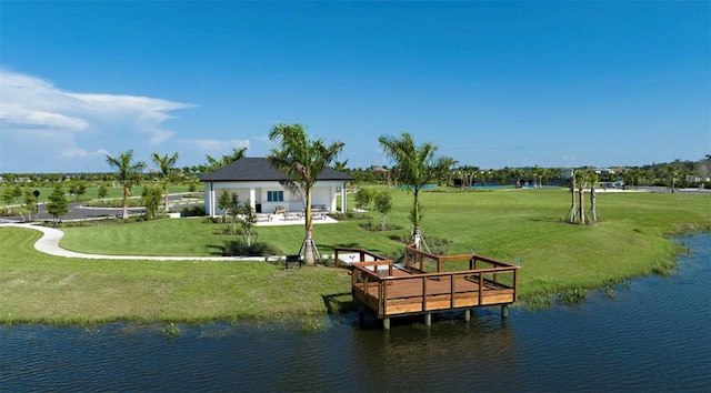 view of dock featuring a lawn and a water view