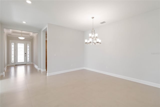 spare room with a notable chandelier and ornamental molding