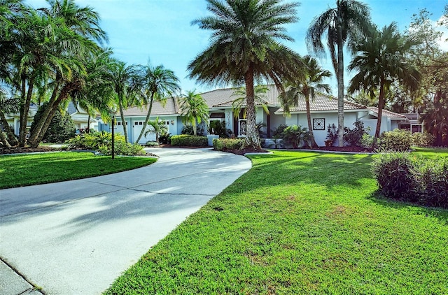 view of front of property featuring a garage and a front yard