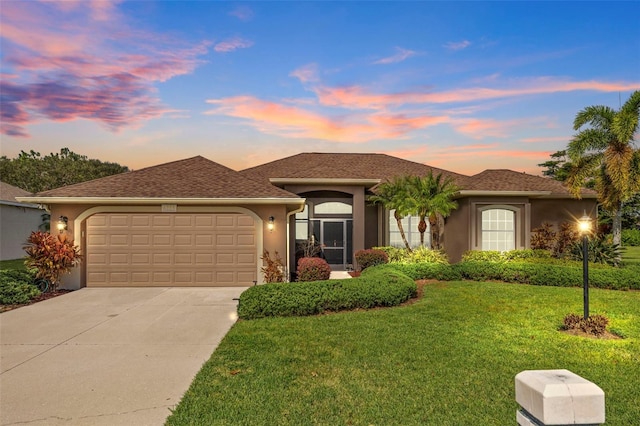 view of front of house featuring a yard and a garage