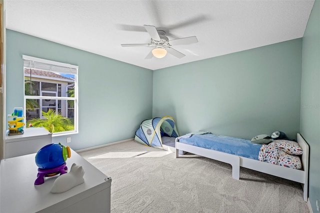 bedroom with ceiling fan and light colored carpet