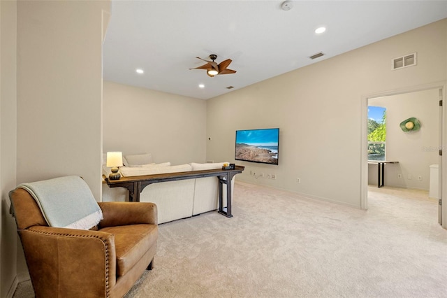 sitting room featuring light carpet and ceiling fan