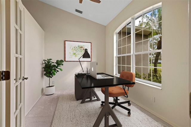 office space with ceiling fan, light carpet, and a wealth of natural light