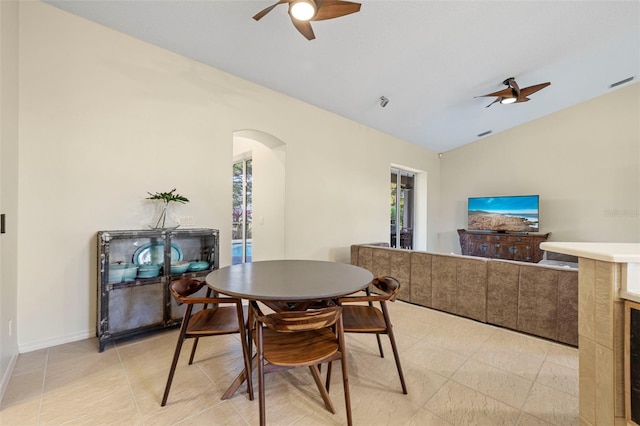 dining space with ceiling fan and lofted ceiling