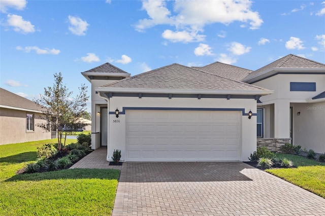 view of front of home with a garage and a front lawn