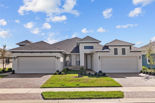 view of front of house featuring a front yard and a garage