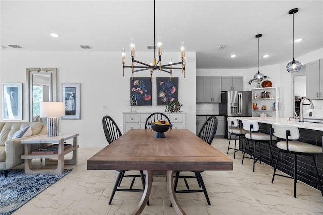 dining room featuring sink and an inviting chandelier