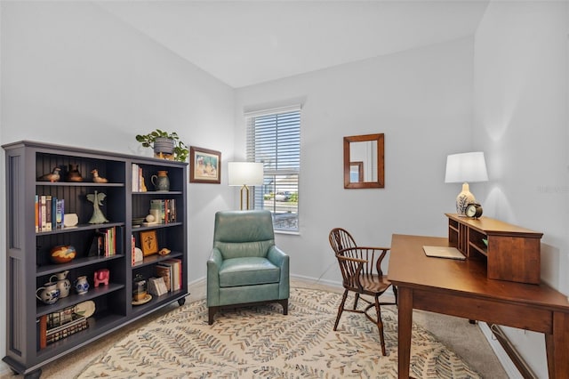 carpeted office space featuring lofted ceiling