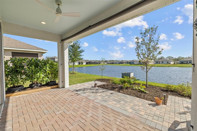 view of patio featuring ceiling fan and a water view