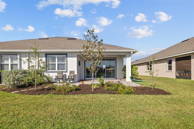 back of property featuring a patio area and a yard