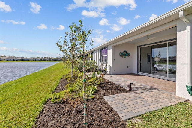 view of yard with a patio area and a water view