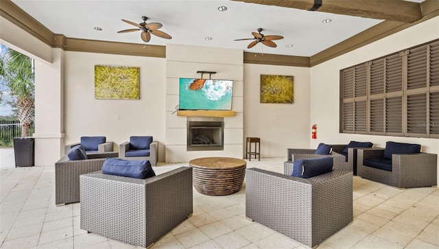 view of patio / terrace with an outdoor living space with a fireplace and ceiling fan