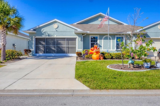 ranch-style house featuring a front yard and a garage