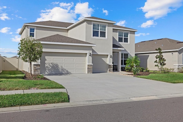 view of front of house with a front yard and a garage