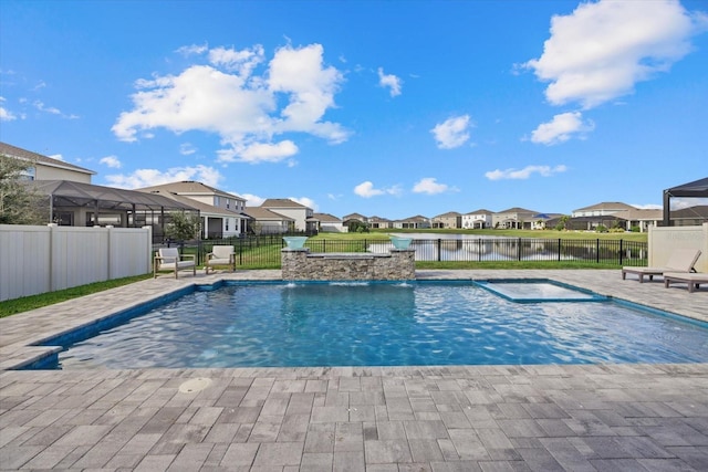 view of swimming pool with pool water feature, a patio area, a water view, and a jacuzzi