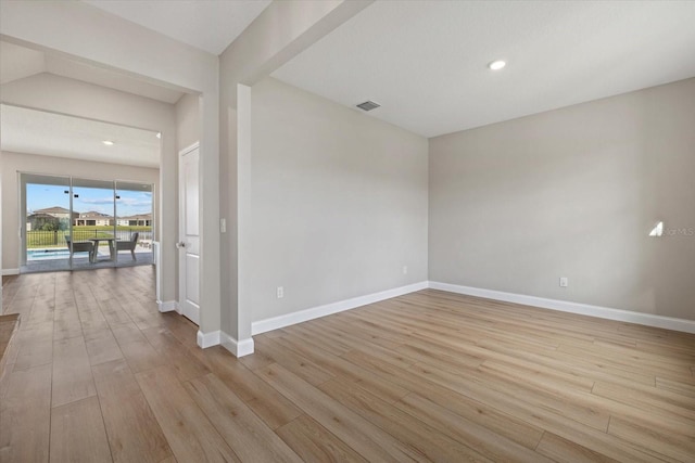 unfurnished room with light wood-type flooring