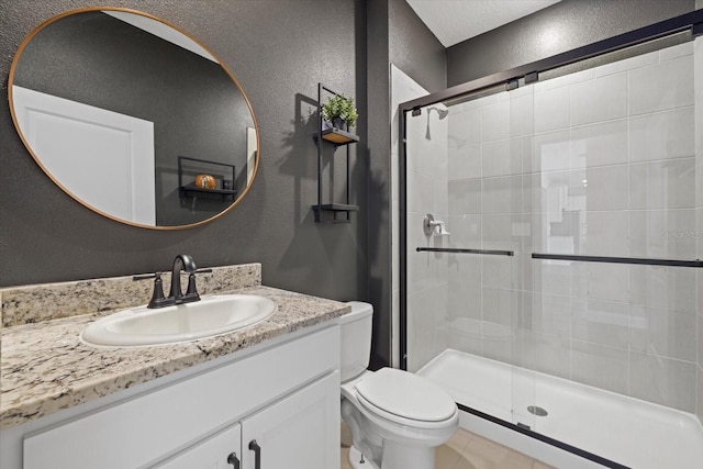 bathroom featuring vanity, toilet, and a shower with shower door