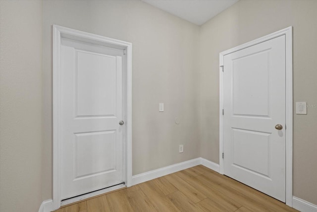 empty room with light hardwood / wood-style flooring