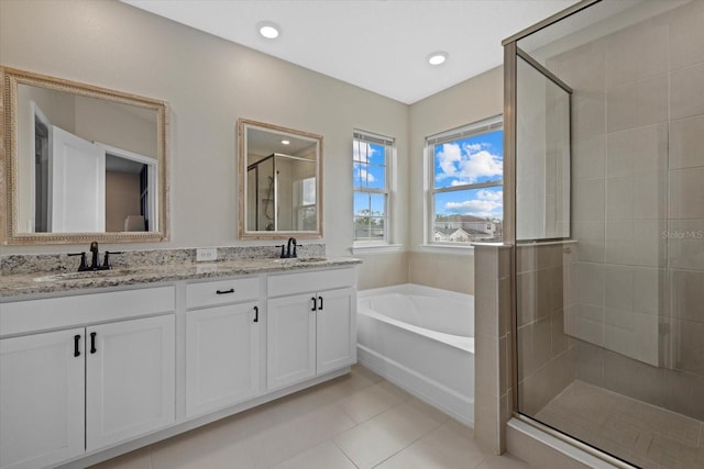 bathroom with tile patterned floors, vanity, and independent shower and bath