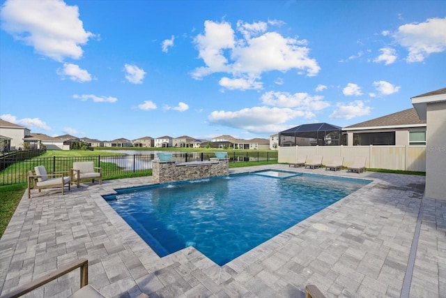 view of swimming pool with a lawn, a patio area, pool water feature, and a water view