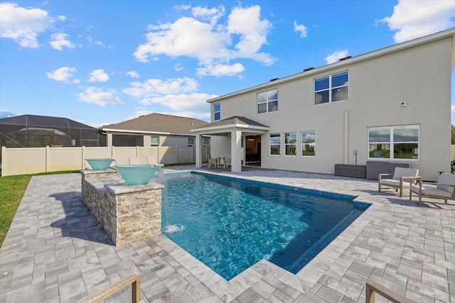 view of swimming pool featuring pool water feature and a patio area