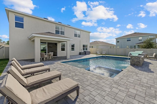 view of pool with an in ground hot tub, pool water feature, and a patio