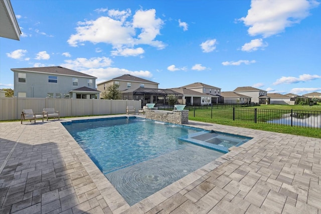 view of swimming pool featuring an in ground hot tub, a yard, a water view, and a patio area