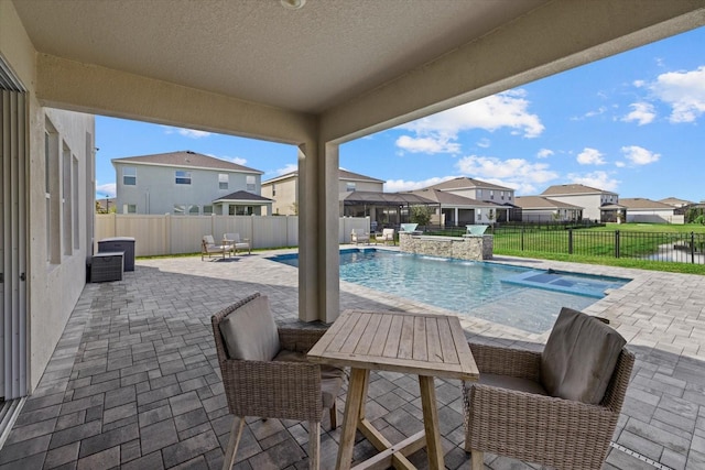 view of swimming pool featuring an in ground hot tub, pool water feature, and a patio area